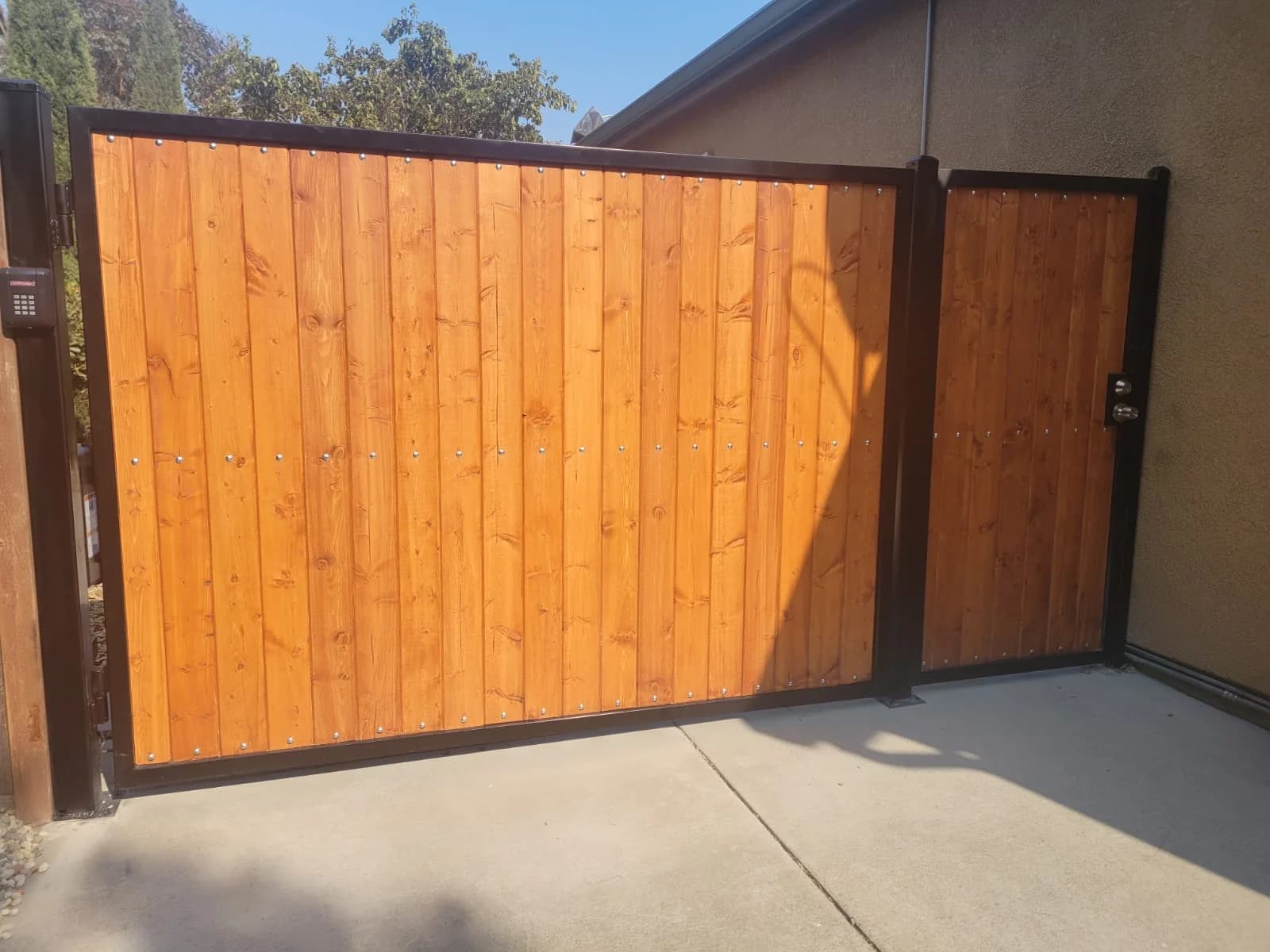 Modern wooden slat automatic gate by SF Bay Automatic Gates